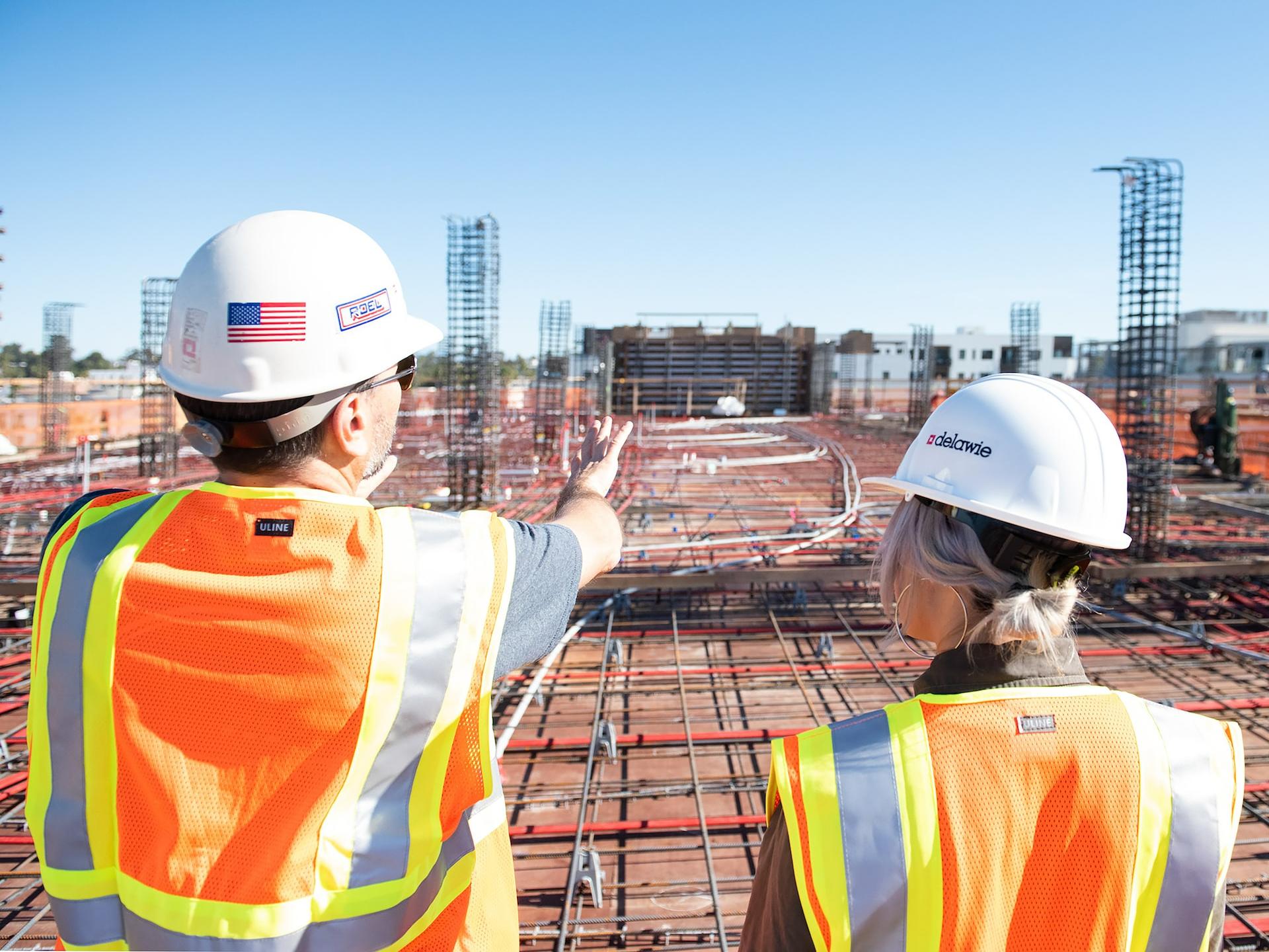 man in white hard hat standing on brown wooden dock during daytime